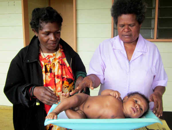 A child being weighed at Mt Hagen MCH clinic