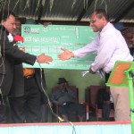 WHPHA CEO Dr James Kintwa (r) thanks Hon Wesley Nukundi