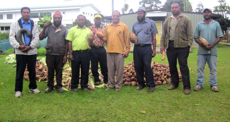Dr. Kintwa (centre) and members of the Nungupi clan displaying some of the food.