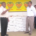 CEO of WHPHA, Dr. James Kintwa (right) thanks Mr Areke and accepts the donation, flanked by Trukai staff.