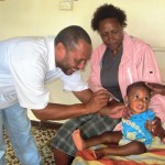 Dr. Richard Kulau of Mendi Hospital checking patient Daniel Hambru from Goroka before he was operated on to correct his upper lips.