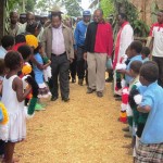 Dr. James Kintwa (right) leading Mr. William Duma and other leaders to the opening of Tipuka Community Health Post.