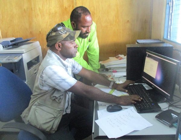 National Finance Department’s Manager PGAS Development, Mathias Luke (front) installing the new system at the WHPHA’s Payment, Accounting and Reporting Services Unit (PARSU), watched by its head and senior accountant, Richard Wak.