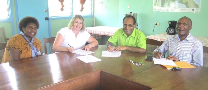 General Manager of Susu Mamas, Moses Moti, then CEO of WHPHA, Dr. James Kintwa and Vice Chairman of Susu Mamas, Anna Maalsen signing the MoA, witnessed by Terasita Waki of Susu Mamas.
