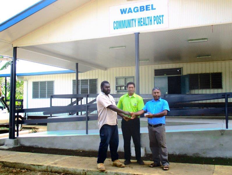 Steward Construction owner, Paul Berry (right) handing over the keys to the Wagbel CHP to WHPHA’s Director Public Health, Benson Safi (centre) and PMU’s team leader, Kenneth Nabuga.