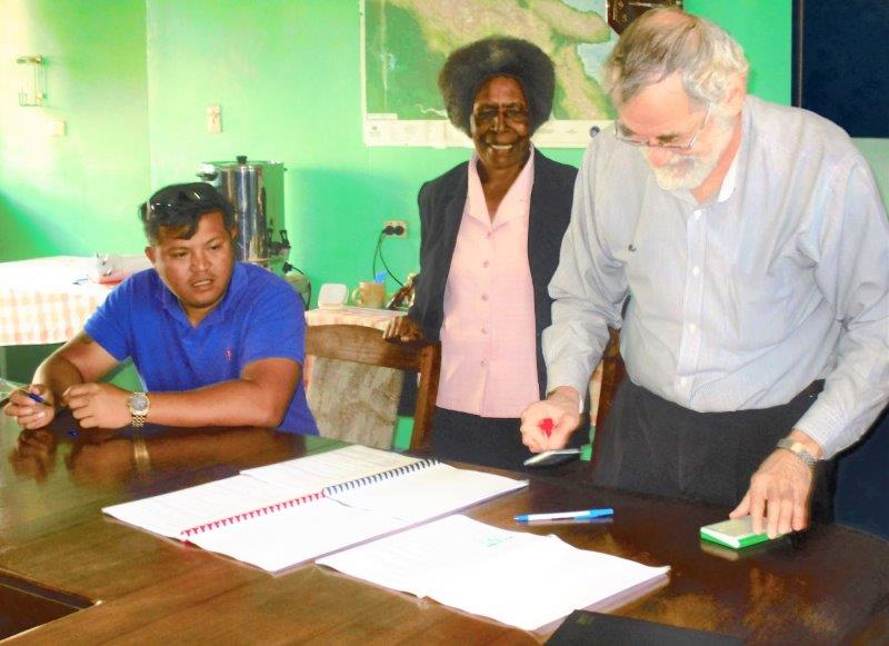 Acting CEO of WHPHA, David Vorst (right) is about to sign the contract while contractor Lloyd Hemlet Imbong (left) and WH Nurses Association President, Mary Culligan await their turn to sign.