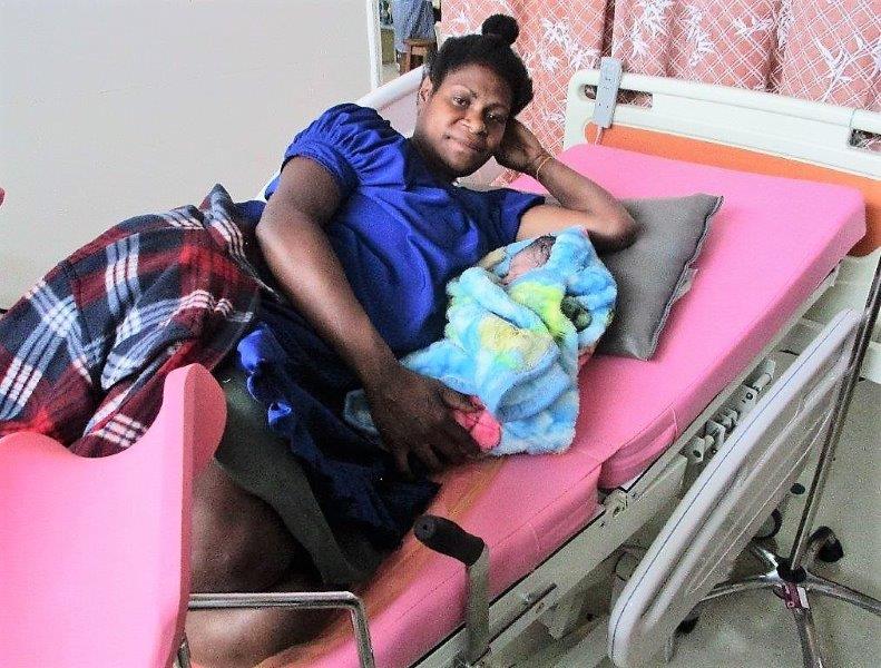 A young mother, Lavina Samuel with her new-born baby girl on one of the new beds.