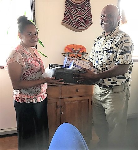 A female representative of the Foundation is pictured receiving the disposable plastic bags from Acting Director Corporate Services, Yasi Anuma.