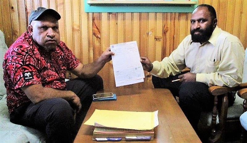 Chief Executive Officer of Dei District, Batamai Tipi (left) presenting the cheque to WHPHA’s team leader for PARSU, Richard Wak.