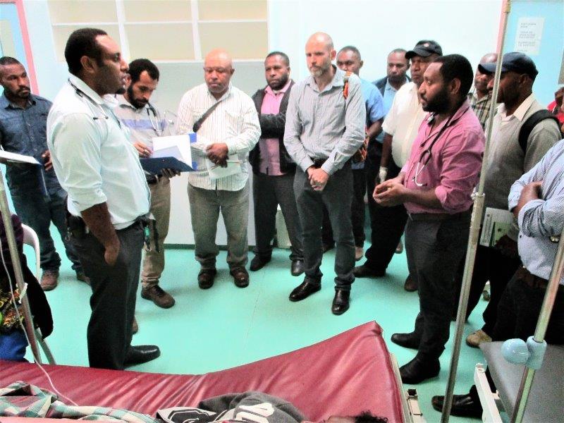 The doctors and health extension officers discuss the diagnosis of a patient and the type of treatment to be given.