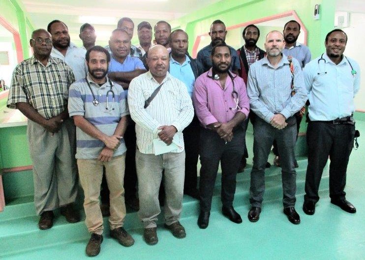 Dr Colin Banks (standing front 2nd from right) is pictured with other doctors and health extension officers after completing their emergency ward round.