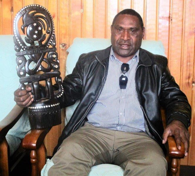 Physiotherapist, David Mambu with a carving from the Milne Bay Province which will be passed on from province to province to indicate the next venue of the symposium.