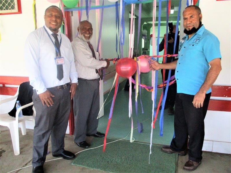 Mr Michael Pundia (left) and Dr Sam Yockopua jointly cutting the ribbon to officially open the refurbished Emergency Department. With them is Emergency Physician, Dr John Junior McKup.