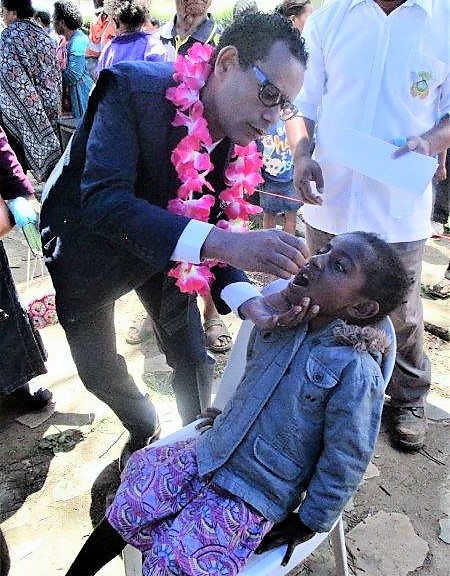 A child receiving her polio dose from Dr Dessie Mekonnen.