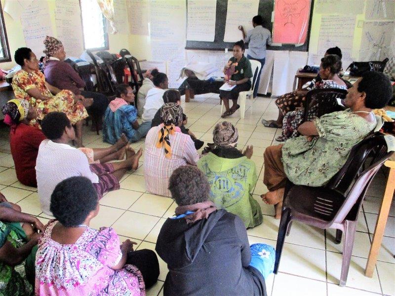 A trainer with the participants in a theory session.