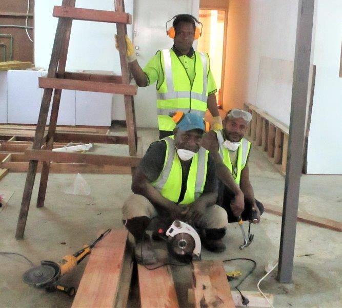 Workmen preparing to cut some timber for a specific job.