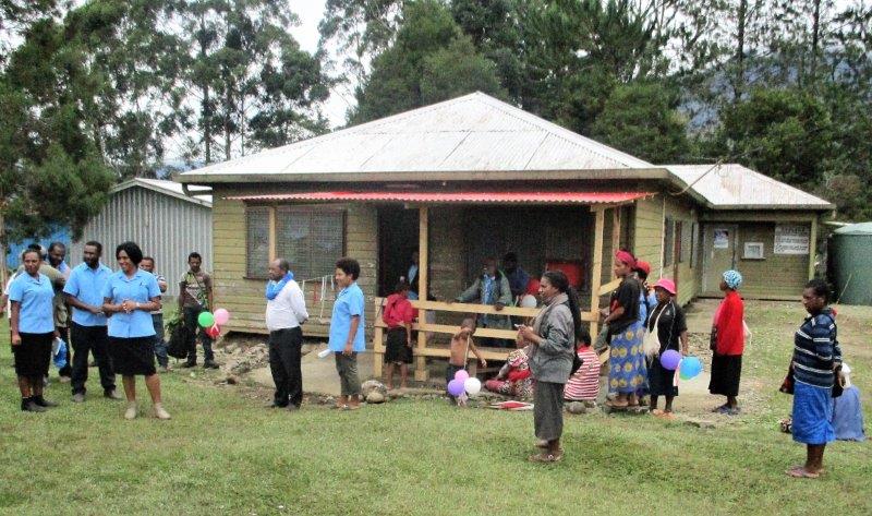 Students and visitors chatting in front of the out-patients building with the newly-added veranda.