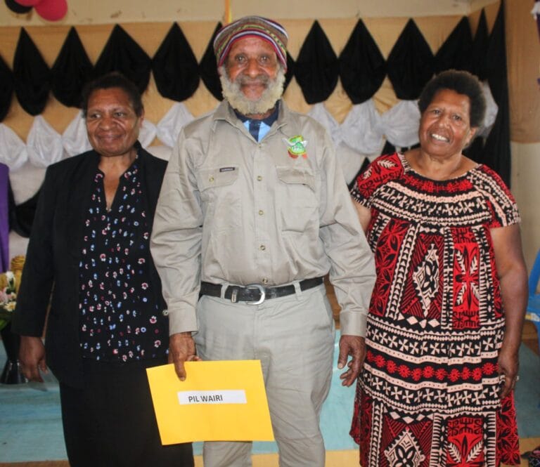 Retiree (Phil Wairi) standing between Sr Yamu (director of nursing services) and WHPHA Board Member Agnes Mek (right)