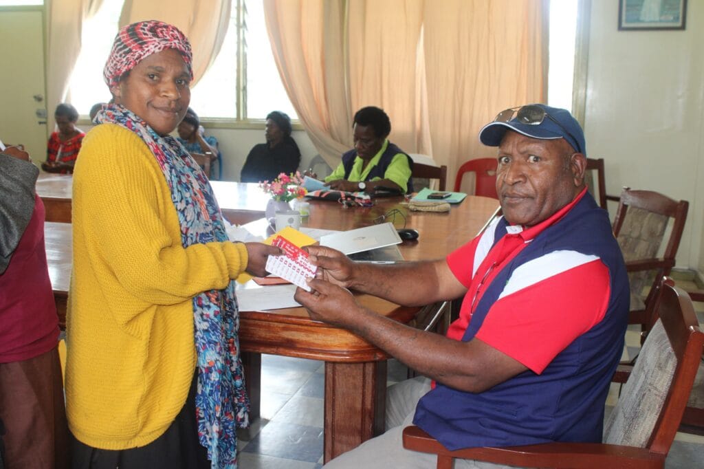 A VHA receives Flex Cards, courtesy of World Vision