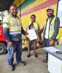 WHPHA Health Inspector Joe Wasia (right) handing over a certificate of condemnation to Trukai Industry’s Quality Control Officer, Mr. Young Kalip, and behind them is Health Inspector Ms. Melissa Steven
