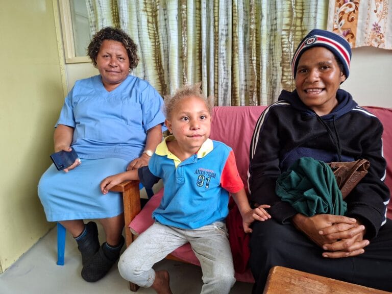 Miracle Frank at 6 years old with mum Agitah and nurse Herica Pupu looks on from behind