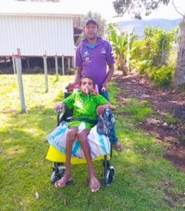 Ismael Paul (in a wheelchair) and his dad