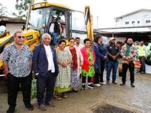 Mr Koim (in excavator) in a group photo with hospital officials and government representatives after the event.