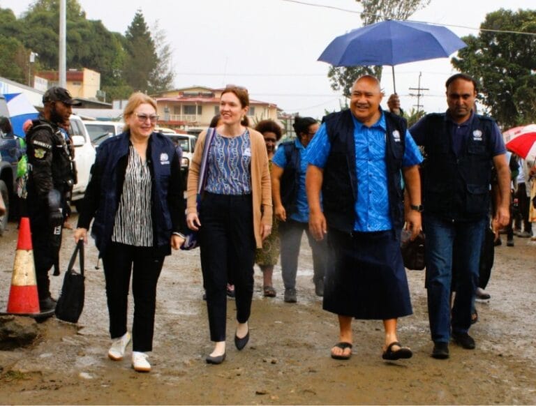 Dr Piukala walks with officials to meet with WHPHA staff and management