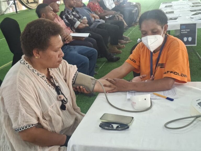 A nurse checks the blood pressure of a public servant as part of the routine wellness screening