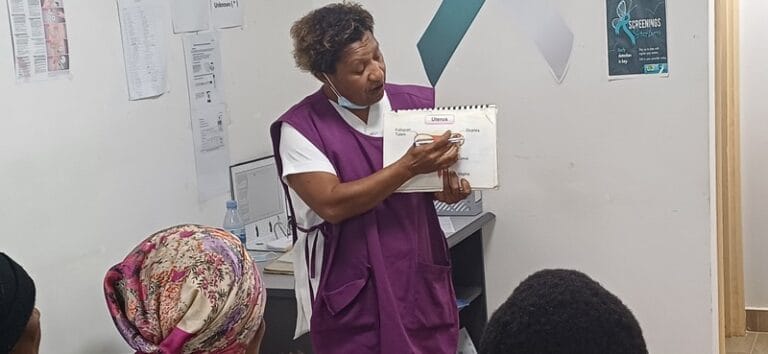 Sr Kuk shows diagrams to bring clarity to the women.
