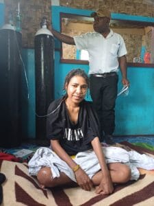 Discharge patient being visited by staff from Mt Hagen Hospital