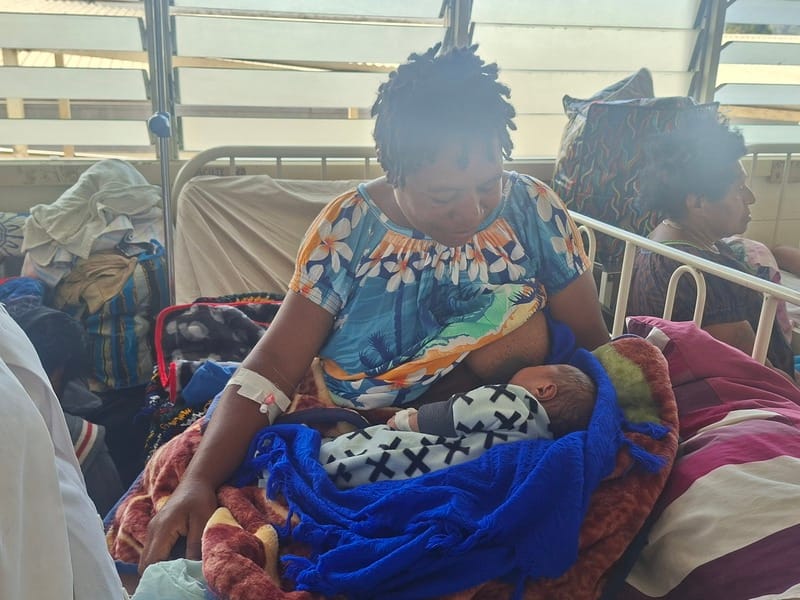 A mother breastfeeding her newborn baby after delivery