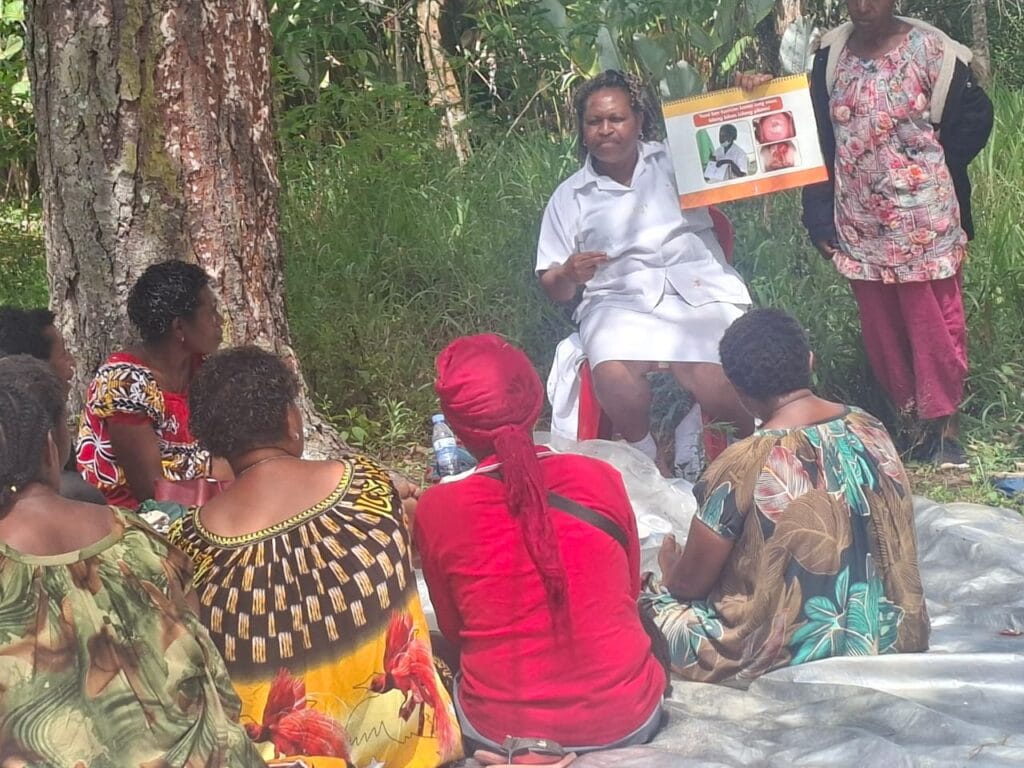 WHPHA’s Nursing Officer Janet Yan, delivers an educational talk on Cervical Cancer to mothers in Mukapeng (Dei District, WHP)