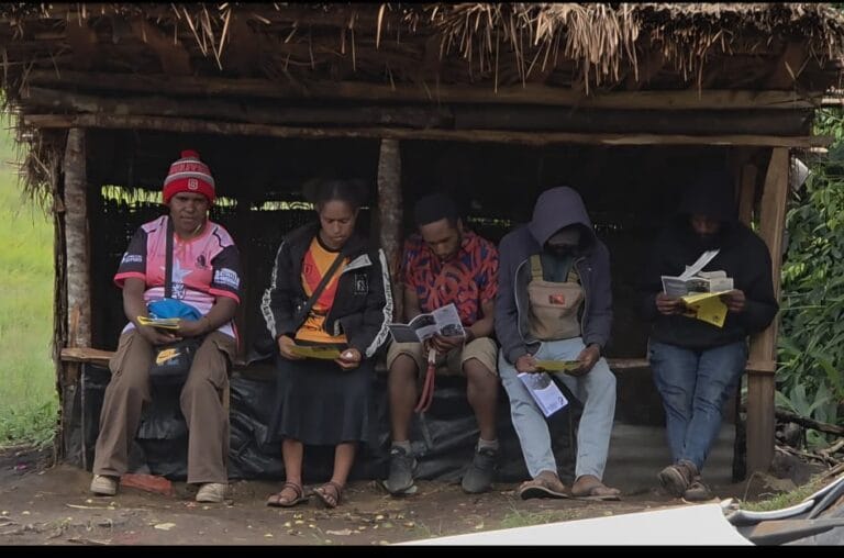 A young man reading the information paper on cervical cancer attentively