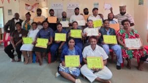 Healthcare workers from Baptist-run health centres in Mul Baiyer District proudly pose for a group photo after completing a week-long Nutrition Training, holding their Certificates of Participation