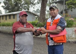 L-R Director for Public Health Mr. Dannax Kupamu receives vehicle key from World Vision’s Grants Operation Supervisor Mr. Richard Kebo